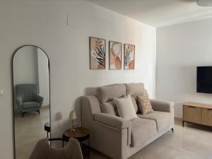 a living room with a couch and a television at Fuente De La Salud in Priego de Córdoba