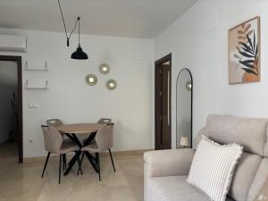 a living room with a table and a couch at Fuente De La Salud in Priego de Córdoba