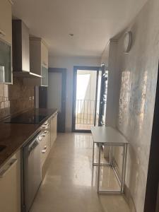 a kitchen with a table in the middle of it at Fuente De La Salud in Priego de Córdoba +9 photos