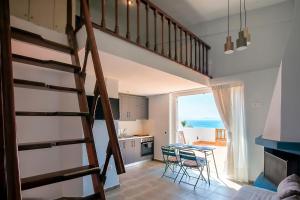 a kitchen with a staircase and a kitchen with a table at FILIPPIDIS suites in Neos Marmaras