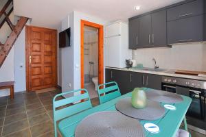 a kitchen with a table and chairs in a kitchen at FILIPPIDIS suites in Neos Marmaras