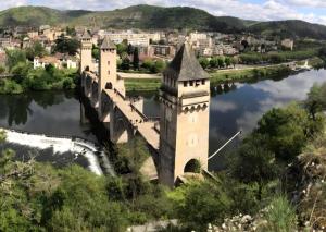 a castle on a bridge over a river at L'Empreinte in Cahors