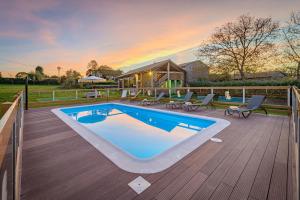 a swimming pool on a wooden deck with a house at CASA DAS XACIAS, RIBEIRA SACRA in A Airoa