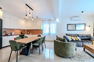 a kitchen and living room with a table and a couch at Apartment Anna - free private parking in Zadar