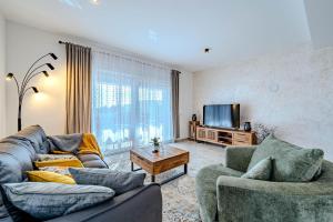 a living room with two couches and a tv at Apartment Anna - free private parking in Zadar