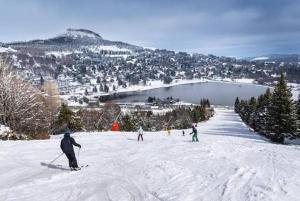 a group of people skiing down a snow covered slope at Petit cocon près des grottes de Perrier in Perrier