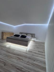 a bedroom with a bed in a white room at Petit cocon près des grottes de Perrier in Perrier