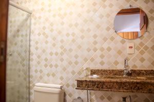 a bathroom with a sink and a toilet and a mirror at Pousada Tetiaroa in Barra Grande +82 photos