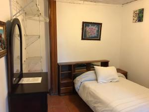 Postel nebo postele na pokoji v ubytování Casa Kibi Kibi