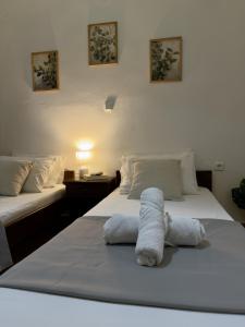 a hotel room with two beds with towels on them at Chrysa's Studios in Loutra Edipsou