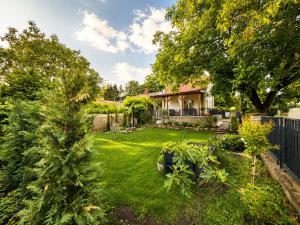 a garden with trees and a house at Balaton Corner in Siófok