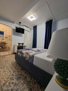 a bedroom with a bed with a lamp and a television at B&B Piazza Mazzini in Catania