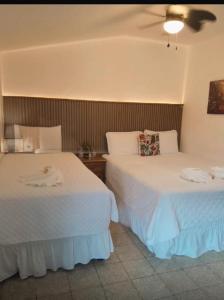 two beds sitting next to each other in a room at Hotel & Restaurante Teresàs Bistro in Antigua Guatemala