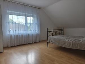 a bedroom with a bed and a large window at Monteurunterkunft nahe Münster in Drensteinfurt