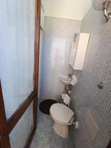 a bathroom with a toilet and a sink at Casa Orchidea in Villasimius +17 photos