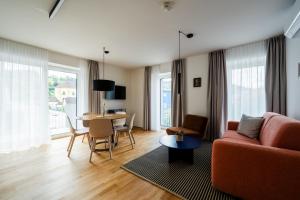 a living room with a couch and a table at Noas Bergisel in Innsbruck