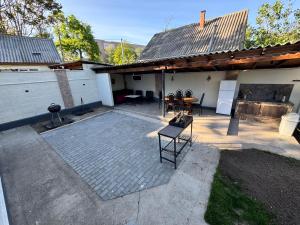 a patio with a table and chairs and a building at Fir Tree Villa in Chişinău