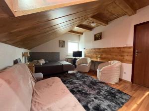 a living room with a couch and a bed at Noclegi U Waldiego in Starachowice