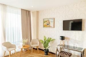 a living room with a flat screen tv on the wall at Blu Mare Residense in Odesa
