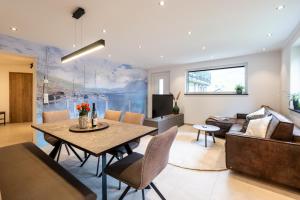 a living room with a table and a couch at Ferienhaus Goldener Anker Unterach am Attersee in Unterach am Attersee