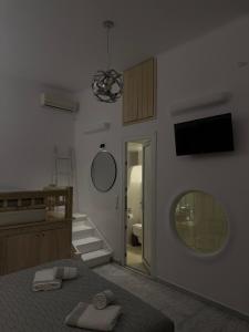 a bedroom with a bed and a mirror on the wall at Starlight Luxury Studios in Mikonos +46 photos