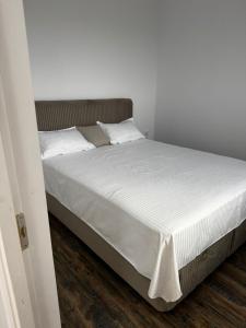 a bed with white sheets and pillows in a bedroom at Escape in Ghelar +33 photos