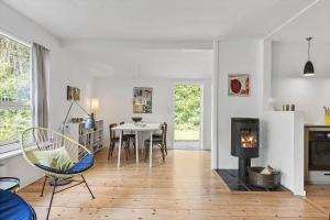 a living room with a fireplace and a table with chairs at 1607-Vejby-Laerkebakken-8 in Vejby