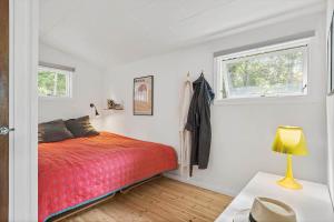 a bedroom with a red bed and a window at 1607-Vejby-Laerkebakken-8 in Vejby