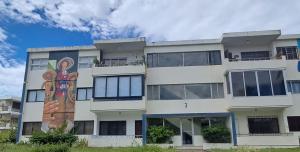 an apartment building with a mural on the side of it at AZUL PUERTO Del MALECON in San Felipe de Puerto Plata