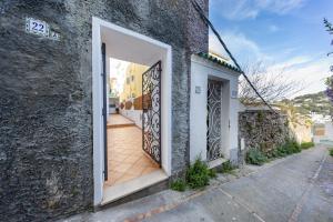 an open door on a building with a sidewalk at Birago22Capri in Capri