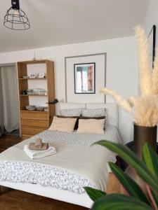 a bedroom with a bed with a towel on it at Idéal couple & pro centre calme, wifi, proche gare in Lamballe