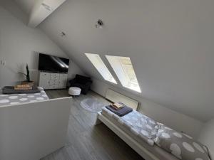 a attic room with two beds and a television at Ferienwohnung am Flughafen in Braunschweig