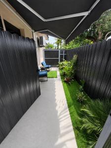 a garden with a black fence and a walkway at Luxury Stay Near Hard Rock Stadium in Miami