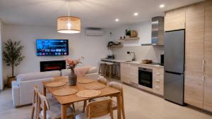 a kitchen and living room with a table and a couch at Casa rural Doble-R in Ronda