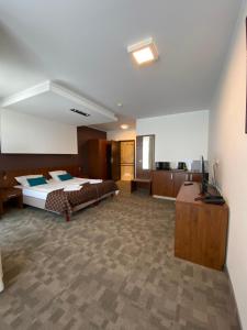 a large room with two beds and a television at Pokoje Hotel Diva 200 metrów do plaży in Kołobrzeg +28 photos