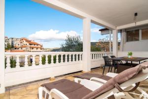 a patio with chairs and a table on a balcony at Apartments Gurman in Rab