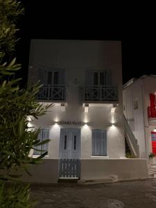 a white building with lights on it at night at Starlight Luxury Studios in Mikonos