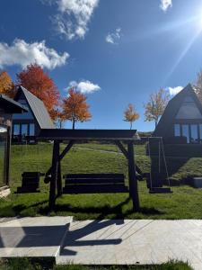 a ping pong table in a park with a house at Escape in Ghelar