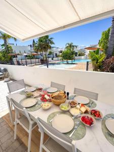 a table with plates of food on a patio at Luxury Costa Blanca Villa near Denia with pool and roof terrace in El Verger