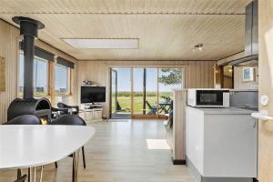 a kitchen and dining room with a table and chairs at SL203-Slagelse-Strandvaenget-46 in Slagelse +16 photos