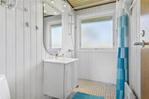 a bathroom with a sink and a mirror at SL203-Slagelse-Strandvaenget-46 in Slagelse