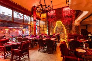 a restaurant with tables and chairs and a stone wall at The Old Ottoman Castle in Istanbul