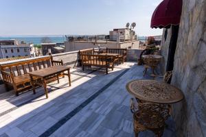 a balcony with benches and tables on a building at The Old Ottoman Castle in Istanbul