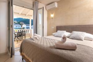 a bedroom with a large bed with towels on it at Apartments Gurman in Rab