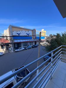 a view of a street with cars parked in front of a building at La Serenité en Puerto Madryn in Puerto Madryn