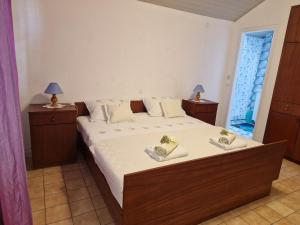 a bedroom with a bed with two shoes on it at Baka Jaka in Lumbarda