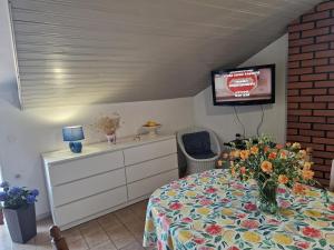 a bedroom with a bed and a tv on a wall at Baka Jaka in Lumbarda