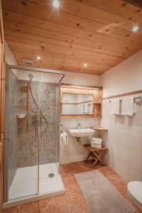 a bathroom with a shower and a sink at Bergbauernhof Simmerl in Sachrang +31 photos
