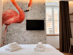 a hotel room with a flamingo on the wall at Luxury Lodge - Moderno Residence vicino alla Stazione in Trieste