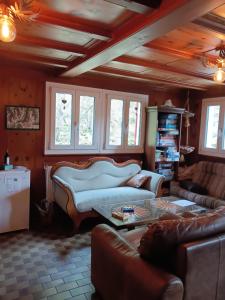 a living room with a couch and a table at Pension Waldegg Zermeiggern in Saas-Almagell